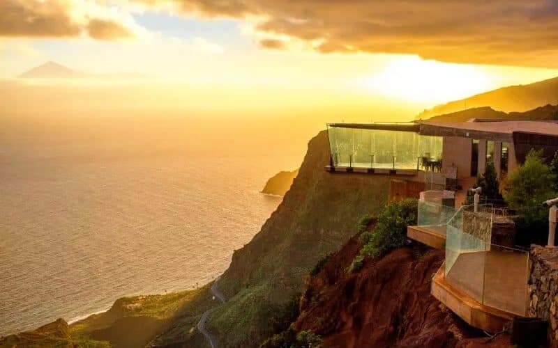 A lookout on a cliff over the sea at sunset